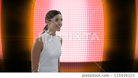 Digital composite of businesswoman wearing safety glasses sliding a digital screen against red spotl Digital composite of businesswoman wearing safety glasses sliding a digital screen against red spotl 115916123
