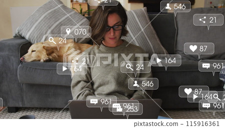 Digital icons on speech bubbles against caucasian woman using laptop while dog sleeping on couch Digital icons on speech bubbles against caucasian woman using laptop while dog sleeping on couch 115916361