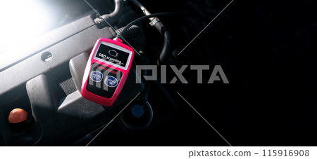 OBD2 or OBD scanner tool on car engine compartment for engine system analysis 115916908