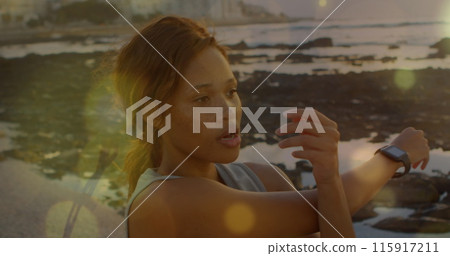 Woman doing stretches on the beach 115917211