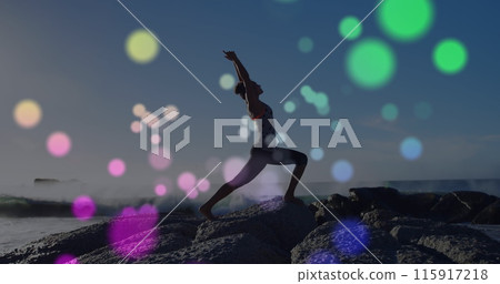 Image of lights over caucasian woman practicing yoga on beach 115917218