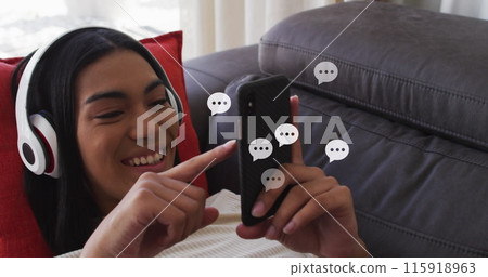 Image of social media icons over biracial woman using smartphone 115918963