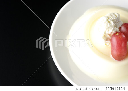 黑色背景下,上面是奶油和葡萄的奶凍的頭頂照片 黑色背景下,上面是奶油和葡萄的奶凍的頭頂照片 115919124