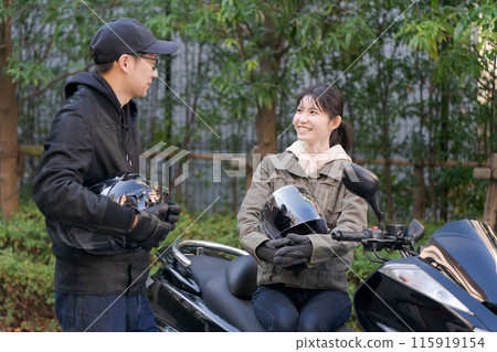 Man and woman talking on a motorcycle Man and woman talking on a motorcycle 115919154