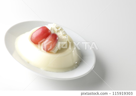 Panna cotta with cream and grapes photographed on a white background Panna cotta with cream and grapes photographed on a white background 115919303