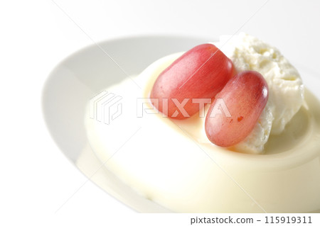 Panna cotta with cream and grapes photographed on a white background 115919311