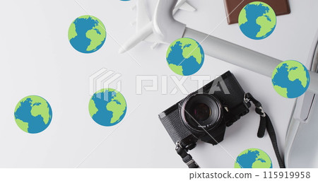 Image of globes over suitcase, passport, camera and plane model on white background 115919958