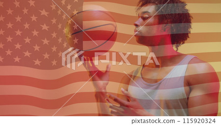 Image of american flag over african american male basketball player spinning ball Image of american flag over african american male basketball player spinning ball 115920324