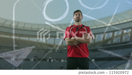 Image of a Caucasian male rugby player standing with crossed arms and looking to camera with hand dr Image of a Caucasian male rugby player standing with crossed arms and looking to camera with hand dr 115920972