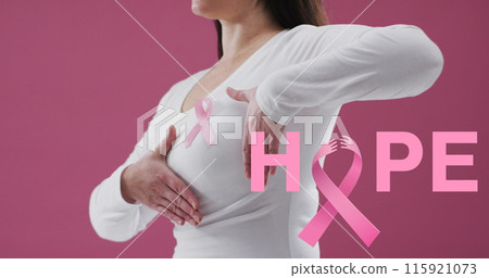 Hope text banner with pink ribbon icon against mid section of woman wearing pink ribbon on her chest 115921073