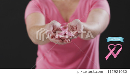 Breast cancer awareness text banner against mid section of woman holding a pink ribbon 115921080