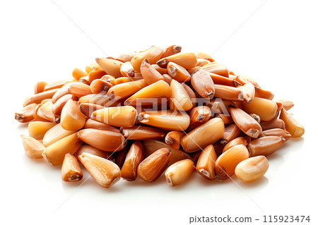 Close-up of shelled and unshelled Pine nuts isolated on a white background, showcasing their texture 115923474