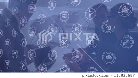 Image of technology icons over diverse businesspeople in office 115923697