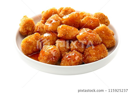 Closeup of golden and crispy Honey BBQ chicken nuggets isolated on a white transparent background 115925237