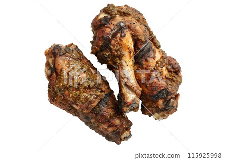 Delicious crispy Jerk chicken wings garnished with fresh cilantro, great for appetizers or main meals 115925998