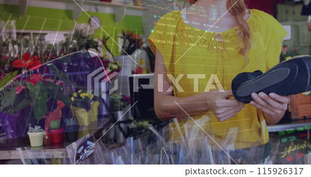 The female florist is using a credit card terminal in the flower shop The female florist is using a credit card terminal in the flower shop 115926317