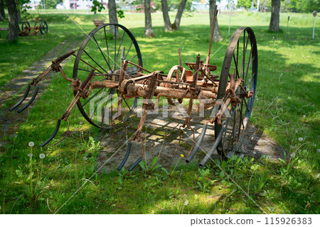 Abandoned old farm equipment 115926383