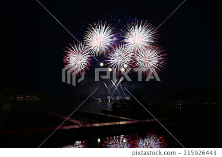 Firework. Beautiful colorful fireworks on the water surface with a clean black background. Fun festival and contest of Firefighters. Brno Dam - Czech Republic. 115926443