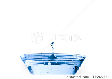 Close-up of water drop falling into a glass on white background 115927162