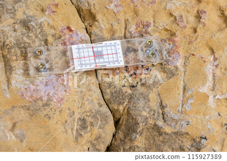 Crack Monitor Installed on Rock Surface 115927389