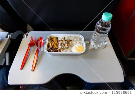 Simple no frills nasi lemak and mineral water served on onboard budget airline 115928691