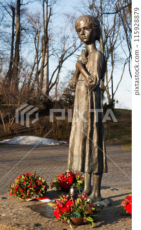 February 19, 2022. Girl with spikelets. Monument near the Holodomor Museum 115928879