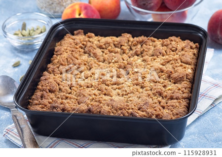 Delicious Peach Crisp or cobbler with brown sugar and oat streusel in backing dish, horizontal Delicious Peach Crisp or cobbler with brown sugar and oat streusel in backing dish, horizontal 115928931