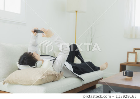 Young man relaxing in the living room 115929165