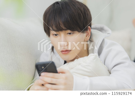 Young man relaxing in the living room 115929174