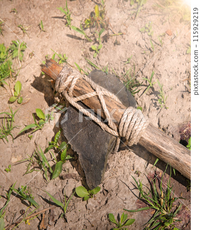 Stone ax of a primitive man Stone ax of a primitive man 115929219