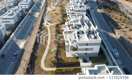 An aerial view of a suburban neighborhood with houses in various shapes and sizes 115929396