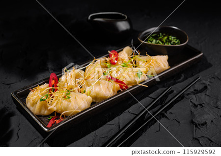 Gourmet asian dumplings on elegant serving platter Gourmet asian dumplings on elegant serving platter 115929592