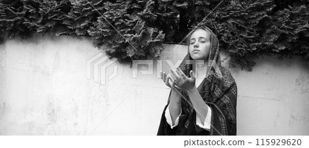 Praying girl in the yard 115929620