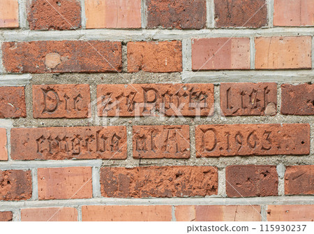Part of brick wall. Inscription in German Dieses Portal ist eingebaut A.D. 1903 on wall of the Kaliningrad Cathedral. This portal is built A.D. 1903 115930237