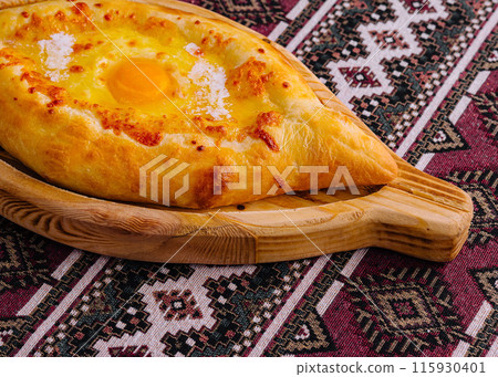 Traditional georgian khachapuri on wooden board Traditional georgian khachapuri on wooden board 115930401