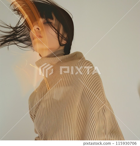 Fashionable woman in a beige sweater with motion effect and light trails, creating a stylish look Fashionable woman in a beige sweater with motion effect and light trails, creating a stylish look 115930706