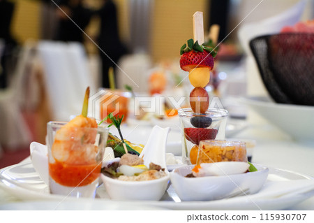 Buffet meals in luxury hotels often include a variety of food options from all over the world. Buffet meals in luxury hotels often include a variety of food options from all over the world. 115930707
