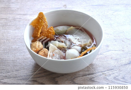 boiled fish and shrimp ball couple dumpling topping pickled cuttlefish in red soybean sauce soup on bowl 115930850