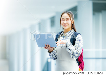Young woman with a laptop Young woman with a laptop 115931651