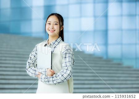 Portrait of a college student with a laptop at university 115931652