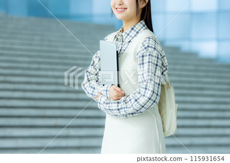 Portrait of a college student with a laptop at university 115931654