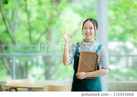 A woman working in a cafe A woman working in a cafe 115931668