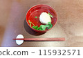 Clear soup served in a red bowl 115932571