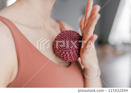 Trainer doing massage movements on the chest with fitness rubber balls. Fitness trainer doing exercises in pilates yoga studio. Concept of beauty, body care, health. Women health club. Trainer doing massage movements on the chest with fitness rubber balls. Fitness trainer doing exercises in pilates yoga studio. Concept of beauty, body care, health. Women health club. 115932894