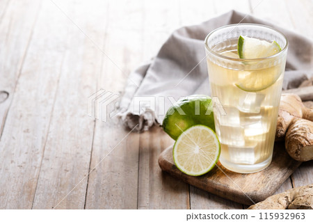Fresh ginger ale drink in tall glass on wooden table Fresh ginger ale drink in tall glass on wooden table 115932963