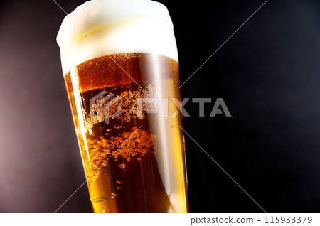 Beer overflowing with bubbles Beer overflowing with bubbles 115933379