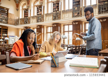 Group of international students working together in the library 115933441