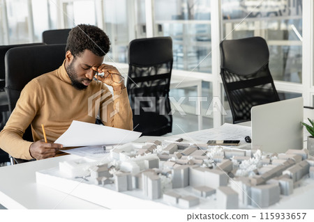 African american architect thinking on a miniature and looking thoughtful 115933657