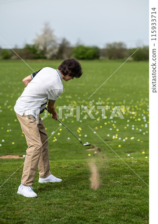 Young guy on a filed with a golf stick 115933714