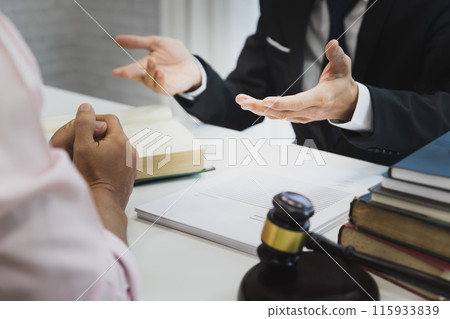 Businessman and lawyer discussing the contract. Sign a contract business. Treaty of the law. Law and Legal services concept. Businessman and lawyer discussing the contract. Sign a contract business. Treaty of the law. Law and Legal services concept. 115933839